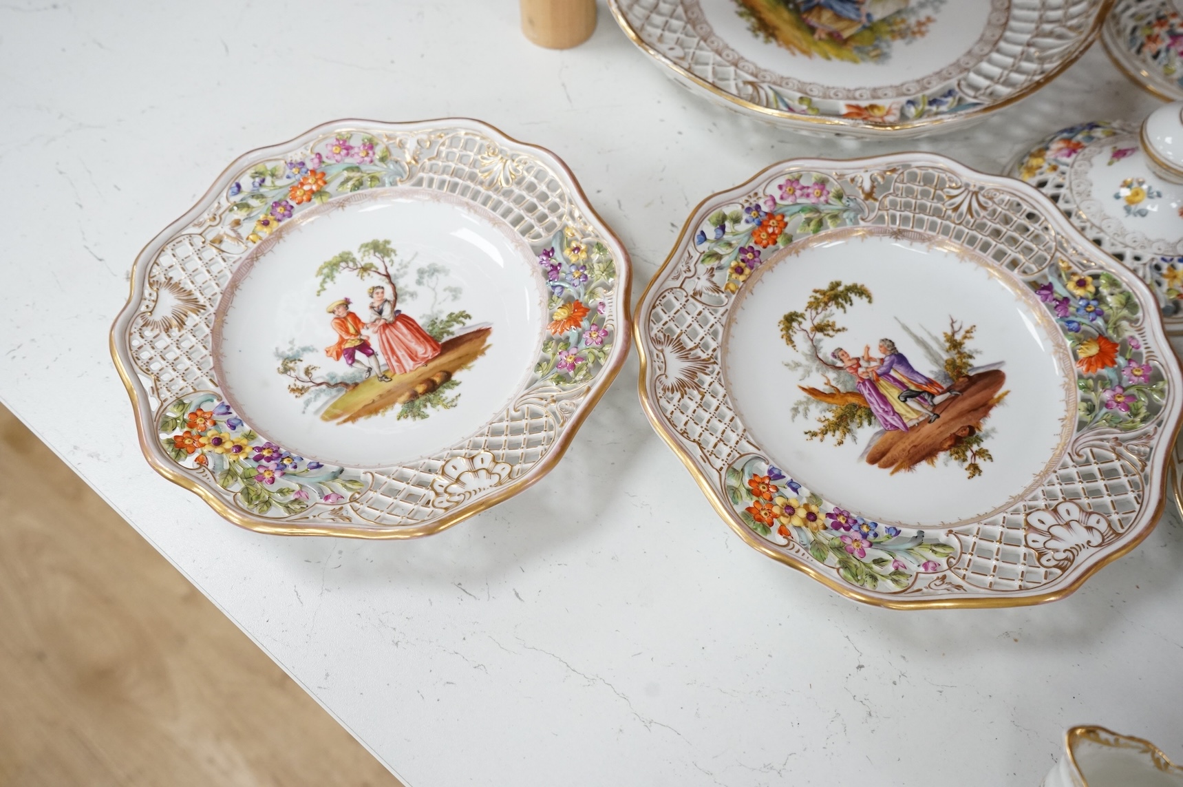 A Dresden porcelain part tea set together with reticulated side plates, largest 26cm in diameter